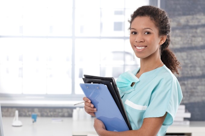 Happy medical worker with case sheets